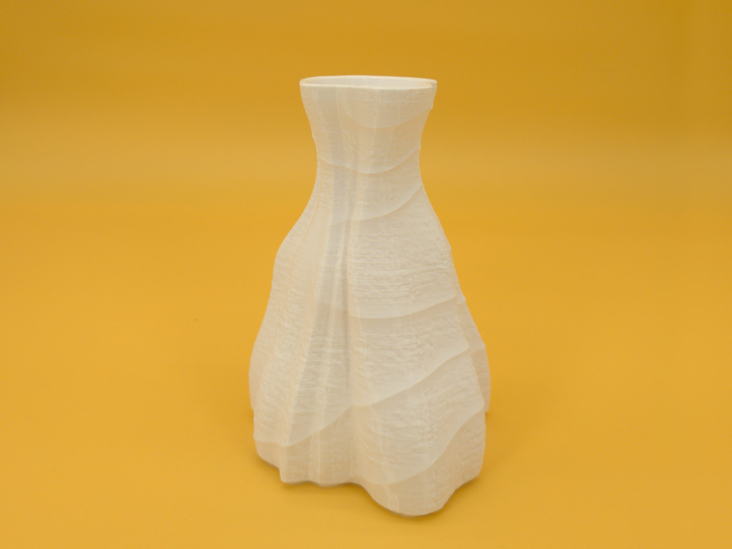 Front view of eco-friendly, pleasing, white vase for dry decoration that features durability and a dual texture with an asymmetric shape!