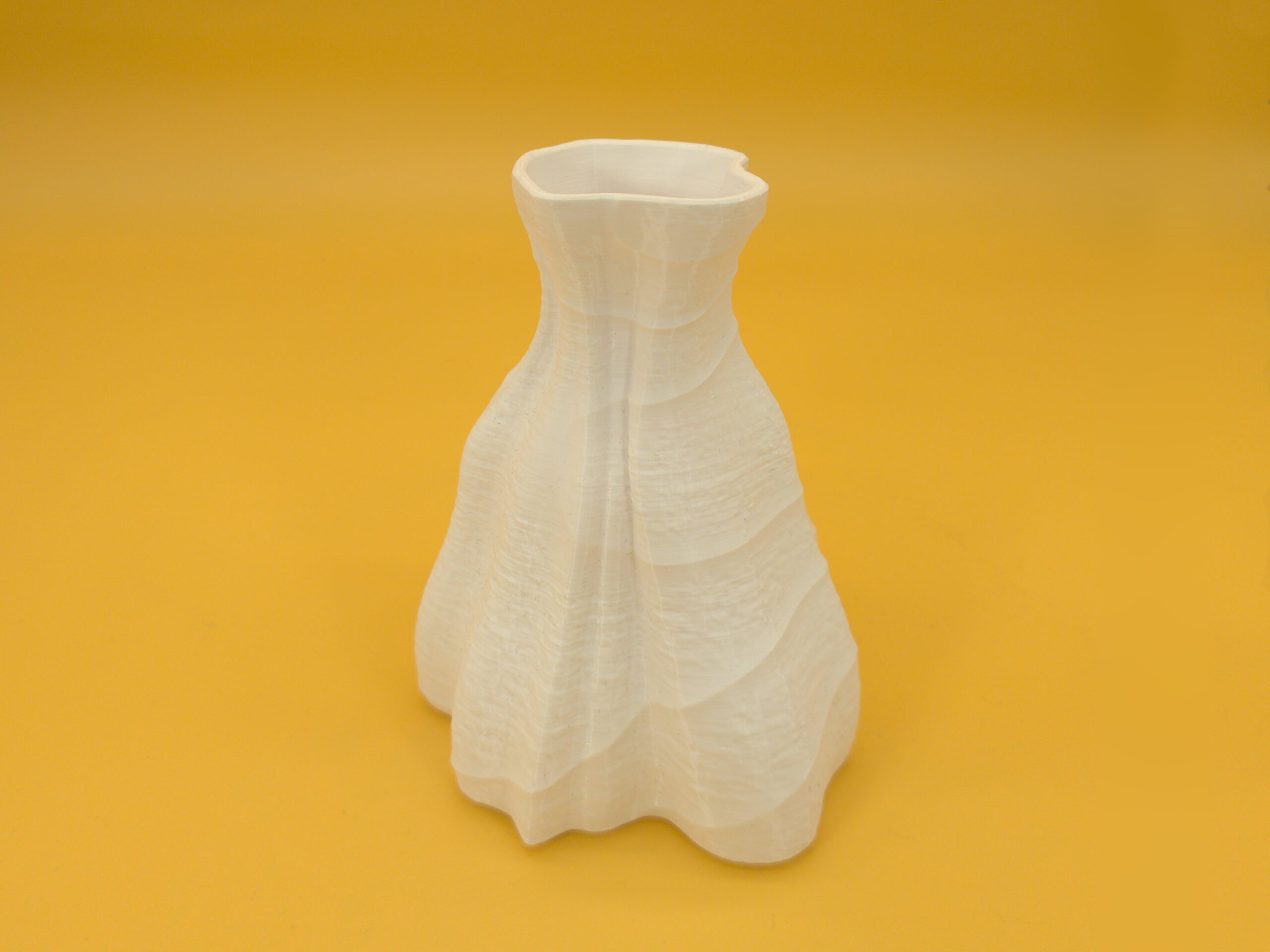 20250909_dual_texture_vase_iso Elevated view of eco-friendly, pleasing, white vase for dry decoration that features durability and a dual texture with an asymmetric shape!