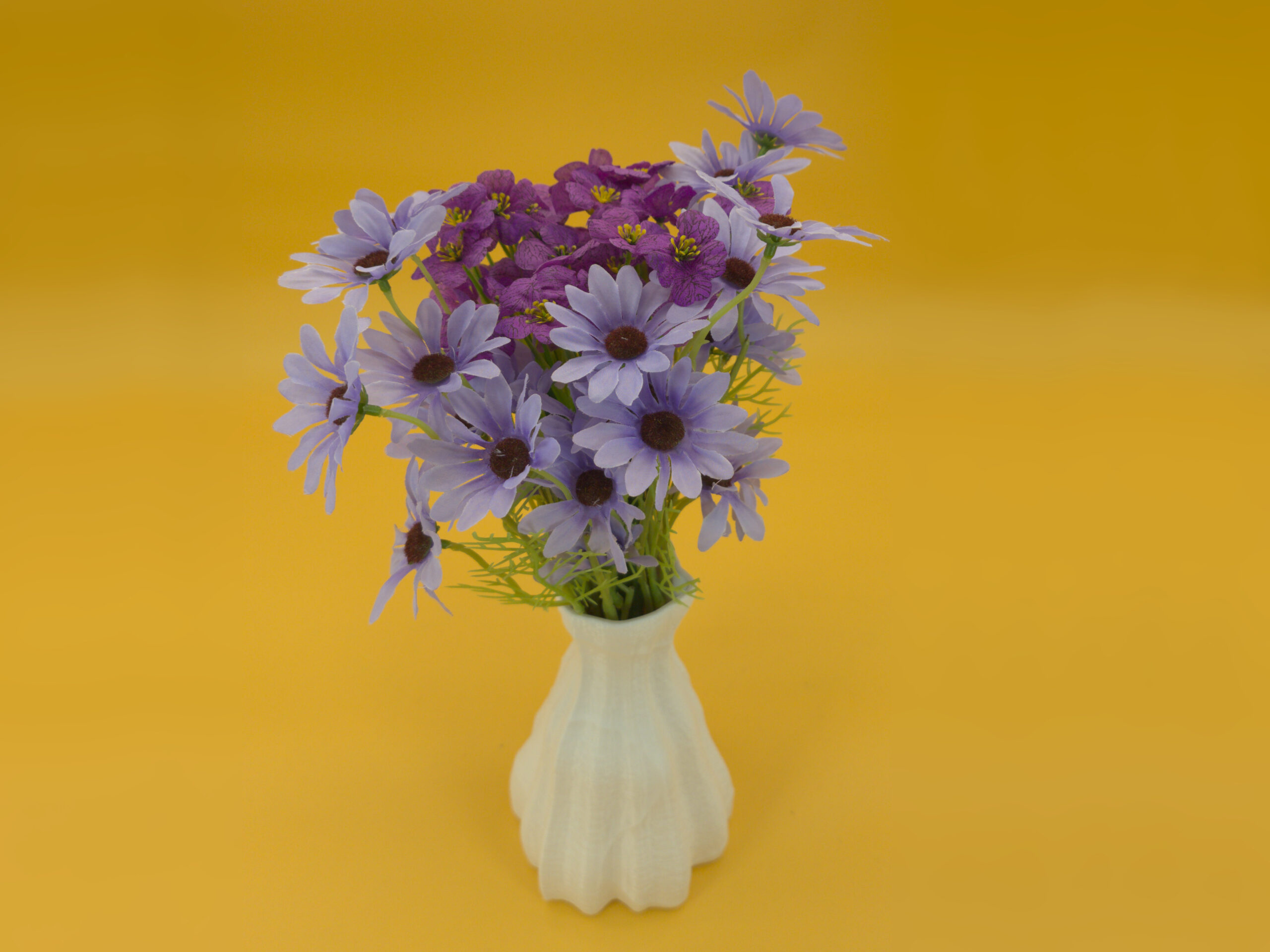 20250909_dual_texture_vase_iso_blue_flowers Elevated view of eco-friendly, pleasing, white vase for dry decoration with cool faux flowers (faux flowers not included).